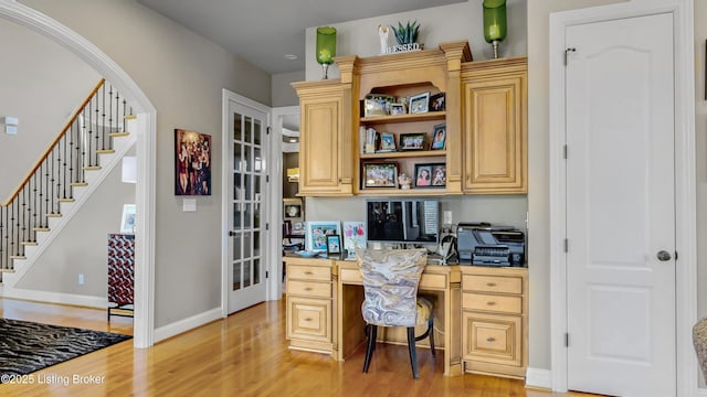 8705 Summit Ridge Dr, Louisville, KY 40241 - home office with built in desk, light wood-type flooring, baseboards, and arched walkways