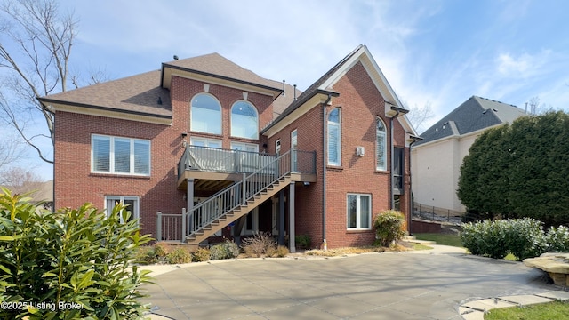 8705 Summit Ridge Dr, Louisville, KY 40241 - rear view of property featuring brick siding, stairs, roof with shingles, and a deck