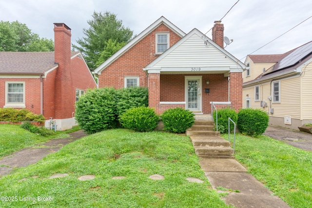 3019 Wirth Ave, Louisville, KY 40217 - bungalow-style house featuring brick siding, a front yard, a chimney, and a porch