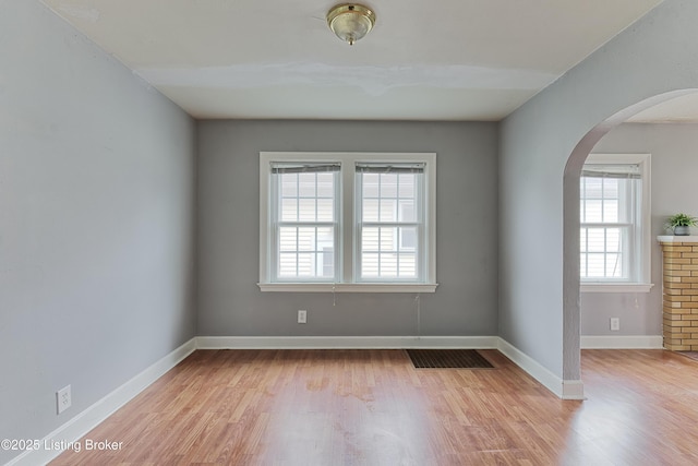 3019 Wirth Ave, Louisville, KY 40217 - empty room with arched walkways and light wood-type flooring