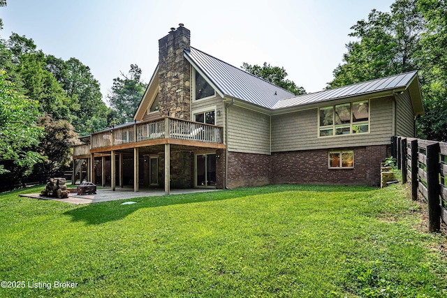 2918 Spickert Knob Rd, Floyds Knobs, IN 47119 - rear view of property with a standing seam roof, a deck, a patio area, a fire pit, and a metal roof