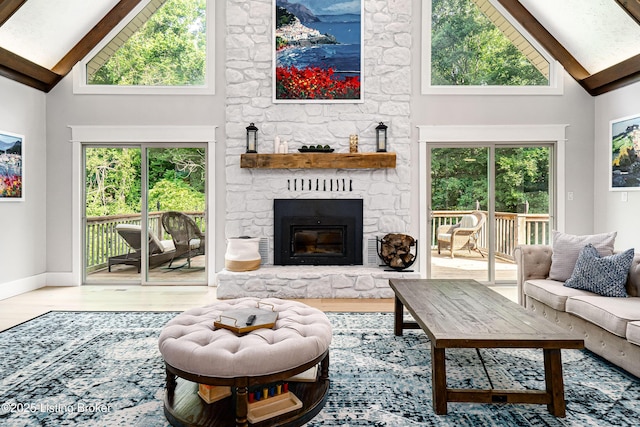 2918 Spickert Knob Rd, Floyds Knobs, IN 47119 - living room featuring high vaulted ceiling, beamed ceiling, wood finished floors, plenty of natural light, and a fireplace