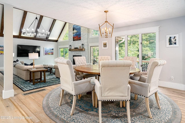 2918 Spickert Knob Rd, Floyds Knobs, IN 47119 - dining area featuring a chandelier, healthy amount of natural light, light wood-style floors, and high vaulted ceiling