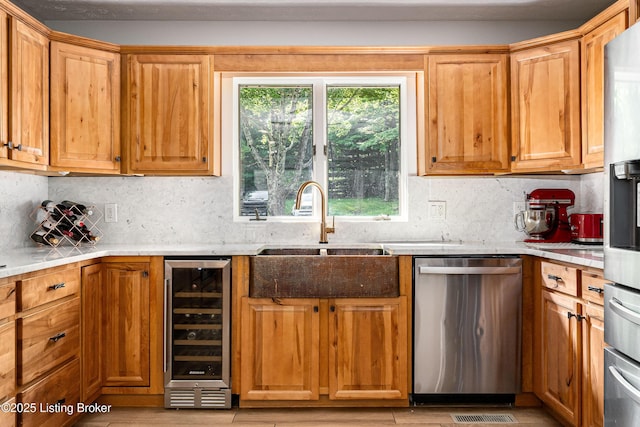 2918 Spickert Knob Rd, Floyds Knobs, IN 47119 - kitchen featuring dishwasher, beverage cooler, light countertops, tasteful backsplash, and light wood-type flooring