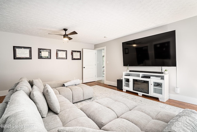 2918 Spickert Knob Rd, Floyds Knobs, IN 47119 - living room featuring ceiling fan, wood finished floors, and a textured ceiling