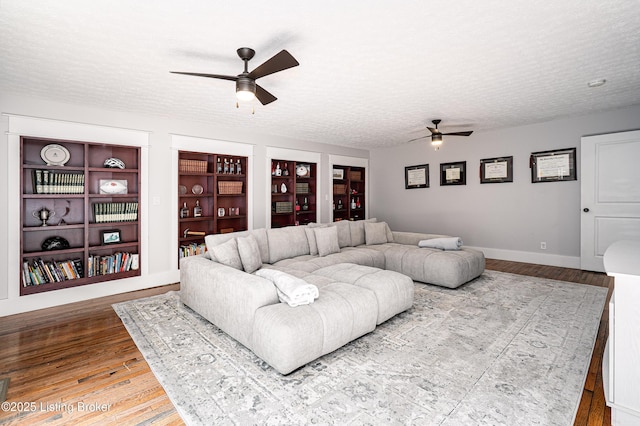 2918 Spickert Knob Rd, Floyds Knobs, IN 47119 - living room featuring a ceiling fan, wood finished floors, a textured ceiling, and built in shelves
