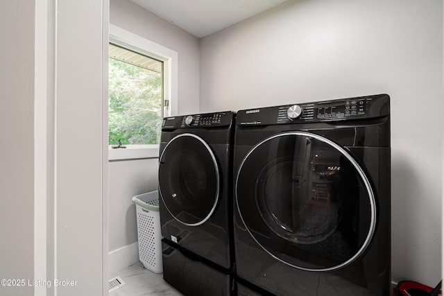 2918 Spickert Knob Rd, Floyds Knobs, IN 47119 - laundry area featuring washer and clothes dryer and marble finish floors