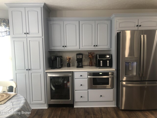 149 Wood Gate Dr, Mt Washington, KY 40047 - kitchen with stainless steel appliances, wine cooler, light countertops, and white cabinetry