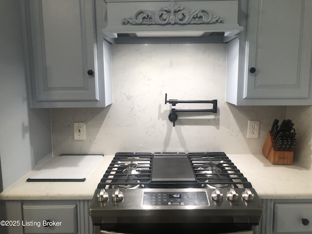 149 Wood Gate Dr, Mt Washington, KY 40047 - kitchen with stove, gray cabinets, and under cabinet range hood