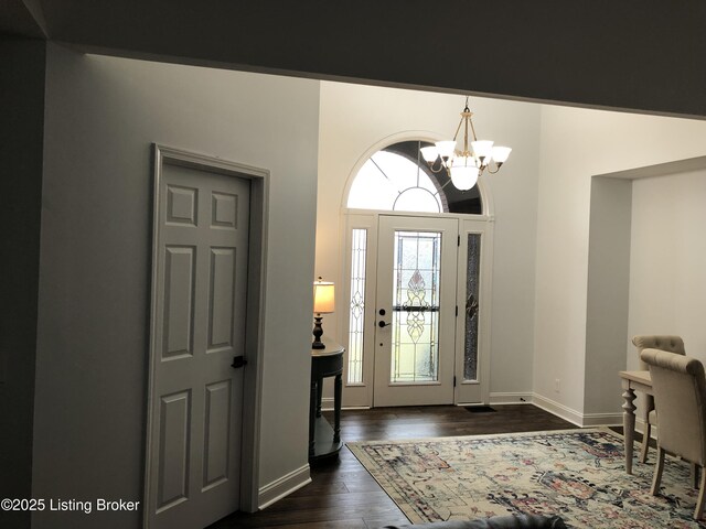 149 Wood Gate Dr, Mt Washington, KY 40047 - foyer with a chandelier and dark wood finished floors