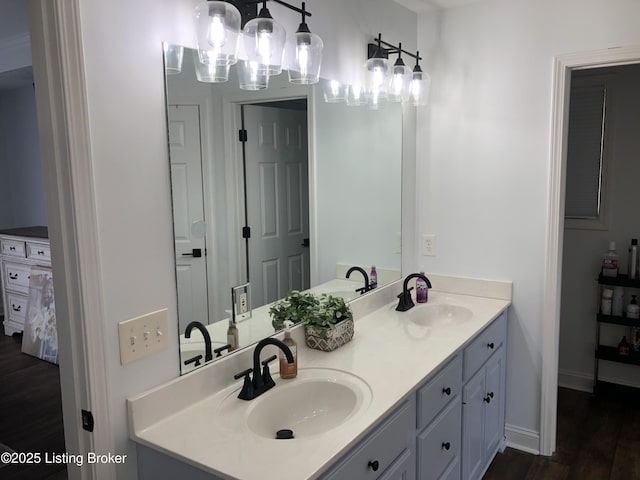 149 Wood Gate Dr, Mt Washington, KY 40047 - bathroom with double vanity, wood finished floors, and a chandelier