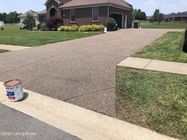149 Wood Gate Dr, Mt Washington, KY 40047 - view of front facade featuring a front yard, driveway, brick siding, and an attached garage