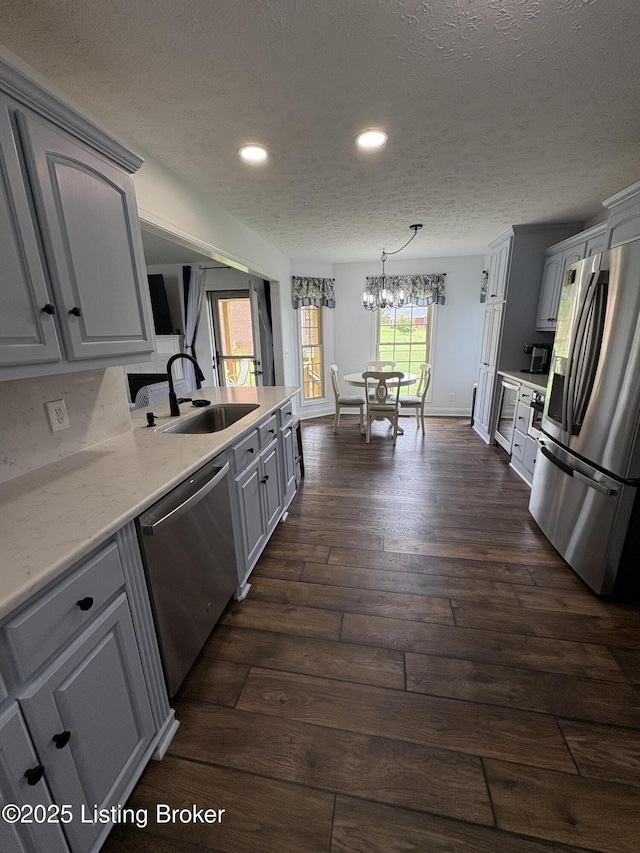 149 Wood Gate Dr, Mt Washington, KY 40047 - kitchen featuring appliances with stainless steel finishes, a textured ceiling, recessed lighting, dark wood-type flooring, and light countertops