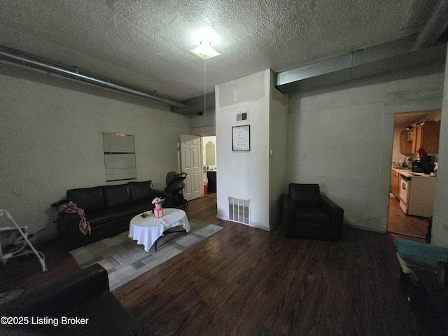 2426 Rowan St, Louisville, KY 40212 - living area with wood finished floors and a textured ceiling