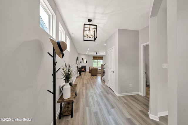 19136 Catalpa Fields Pl, Louisville, KY 40023 - hall featuring light wood finished floors, a chandelier, and recessed lighting