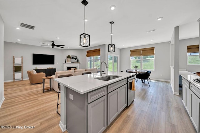 19136 Catalpa Fields Pl, Louisville, KY 40023 - kitchen with gray cabinets, light wood-style floors, light countertops, dishwasher, and recessed lighting
