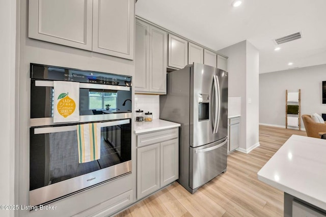 19136 Catalpa Fields Pl, Louisville, KY 40023 - kitchen with appliances with stainless steel finishes, gray cabinets, light wood-style floors, recessed lighting, and light countertops