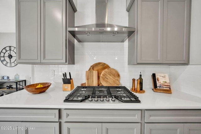 19136 Catalpa Fields Pl, Louisville, KY 40023 - kitchen with wall chimney exhaust hood, gray cabinetry, stainless steel gas stovetop, and decorative backsplash