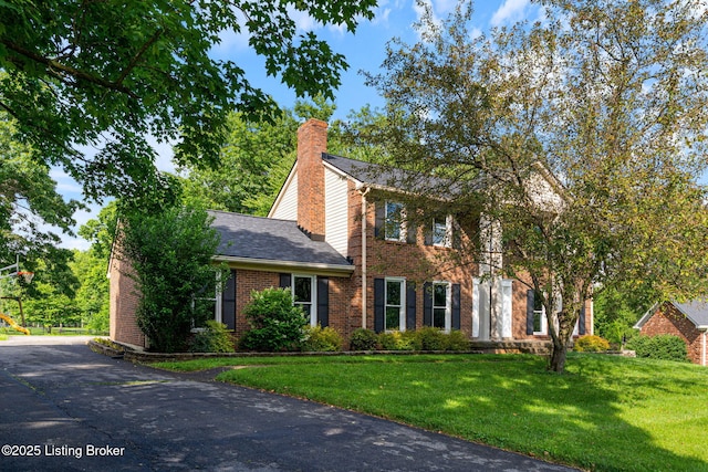 3627 E Locust Cir, Prospect, KY 40059 - view of front facade featuring brick siding, a front lawn, a chimney, and a shingled roof