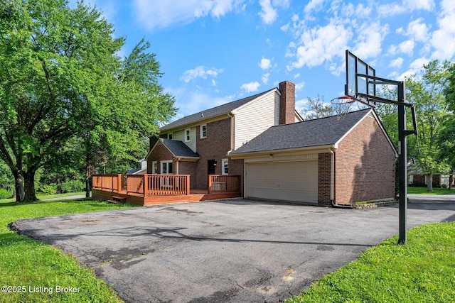 3627 E Locust Cir, Prospect, KY 40059 - rear view of property with an attached garage, driveway, a chimney, a wooden deck, and brick siding