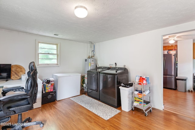 703 Cheri Way, Fairdale, KY 40118 - laundry room featuring independent washer and dryer, wood finished floors, an office area, gas water heater, and a textured ceiling