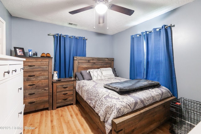 703 Cheri Way, Fairdale, KY 40118 - bedroom with light wood finished floors, ceiling fan, and a textured ceiling