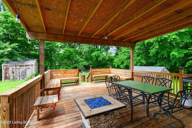 703 Cheri Way, Fairdale, KY 40118 - wooden terrace featuring a storage unit, an outdoor fire pit, and outdoor dining space