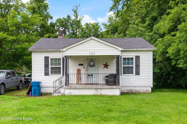 703 Cheri Way, Fairdale, KY 40118 - bungalow-style home featuring a porch, a front lawn, roof with shingles, and a chimney