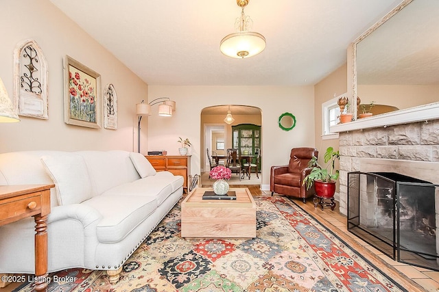 114 S Crestmoor Ave, Louisville, KY 40206 - living room with arched walkways, a fireplace, and wood finished floors