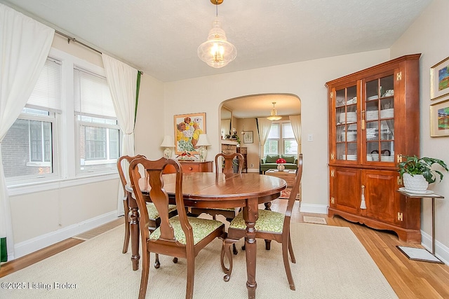 114 S Crestmoor Ave, Louisville, KY 40206 - dining space with arched walkways and light wood-type flooring