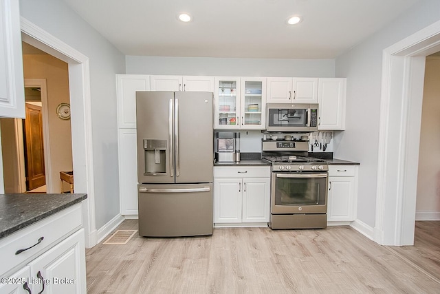 114 S Crestmoor Ave, Louisville, KY 40206 - kitchen with appliances with stainless steel finishes, light wood-type flooring, glass insert cabinets, white cabinetry, and recessed lighting