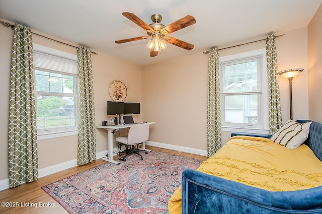 114 S Crestmoor Ave, Louisville, KY 40206 - bedroom featuring multiple windows, wood finished floors, a desk, and a ceiling fan