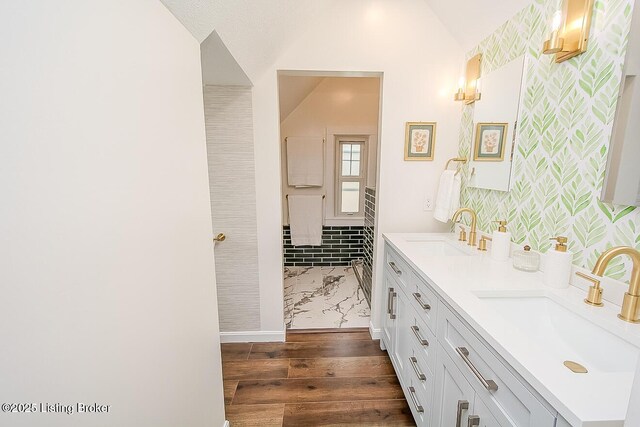 114 S Crestmoor Ave, Louisville, KY 40206 - full bath with wood finished floors, vaulted ceiling, double vanity, and wallpapered walls