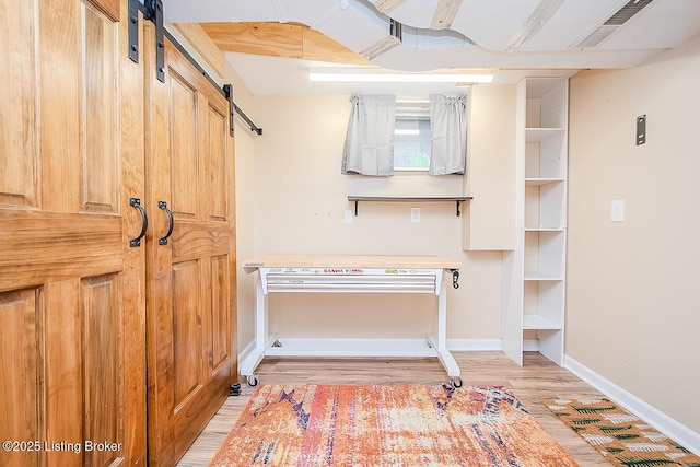 114 S Crestmoor Ave, Louisville, KY 40206 - below grade area with a barn door and light wood-style flooring