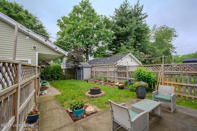 114 S Crestmoor Ave, Louisville, KY 40206 - fenced backyard featuring an outdoor fire pit, a storage unit, and a patio