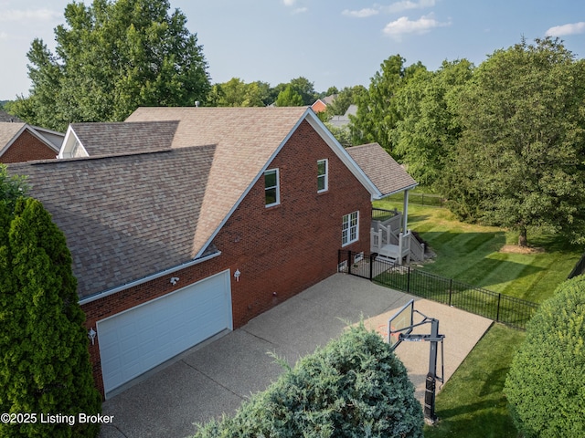 6205 Elizabeth Ct, Prospect, KY 40059 - view of home's exterior featuring roof with shingles, brick siding, an attached garage, and concrete driveway