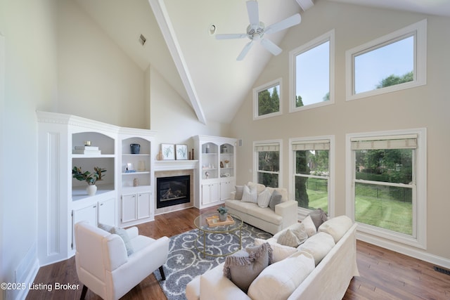 6205 Elizabeth Ct, Prospect, KY 40059 - living area with high vaulted ceiling, dark wood-style flooring, a glass covered fireplace, a ceiling fan, and beamed ceiling