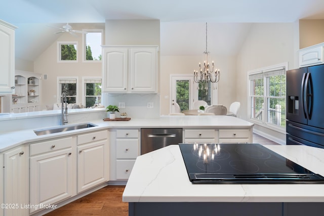 6205 Elizabeth Ct, Prospect, KY 40059 - kitchen featuring black refrigerator with ice dispenser, stovetop, a chandelier, a peninsula, and a ceiling fan