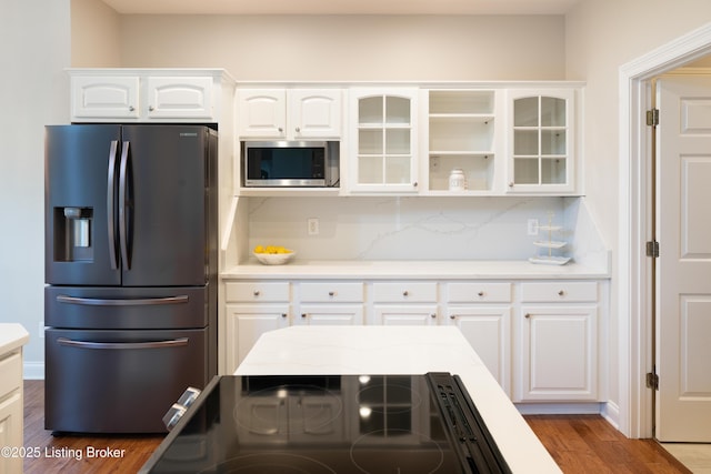 6205 Elizabeth Ct, Prospect, KY 40059 - kitchen featuring refrigerator with ice dispenser, stainless steel microwave, glass insert cabinets, wood finished floors, and white cabinetry