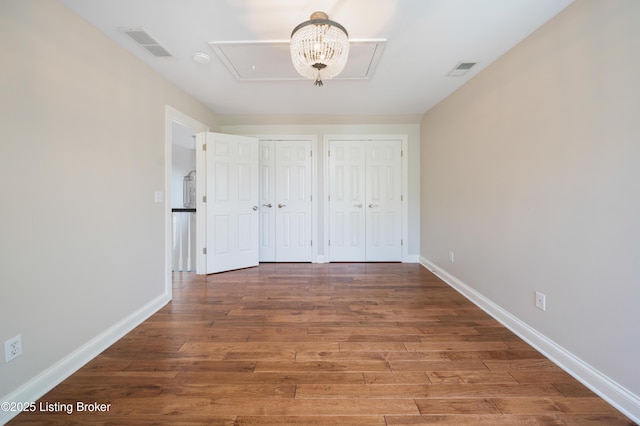 6205 Elizabeth Ct, Prospect, KY 40059 - unfurnished bedroom featuring attic access, two closets, and wood finished floors