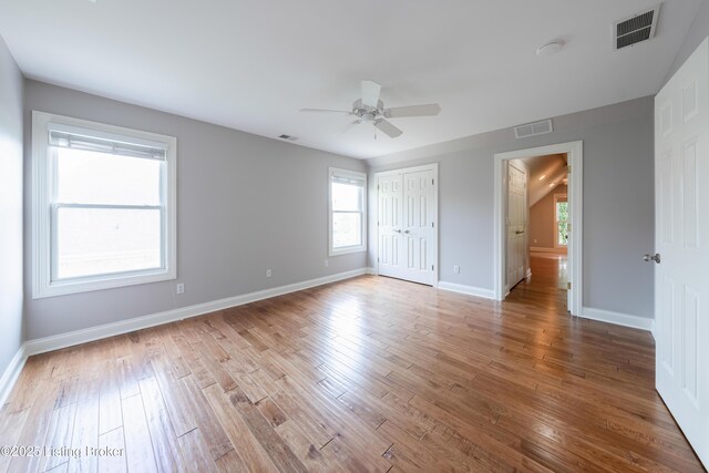 6205 Elizabeth Ct, Prospect, KY 40059 - unfurnished bedroom with multiple windows, wood finished floors, and ceiling fan