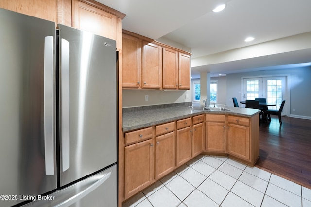 6205 Elizabeth Ct, Prospect, KY 40059 - kitchen featuring freestanding refrigerator, dark countertops, a peninsula, recessed lighting, and light tile patterned floors