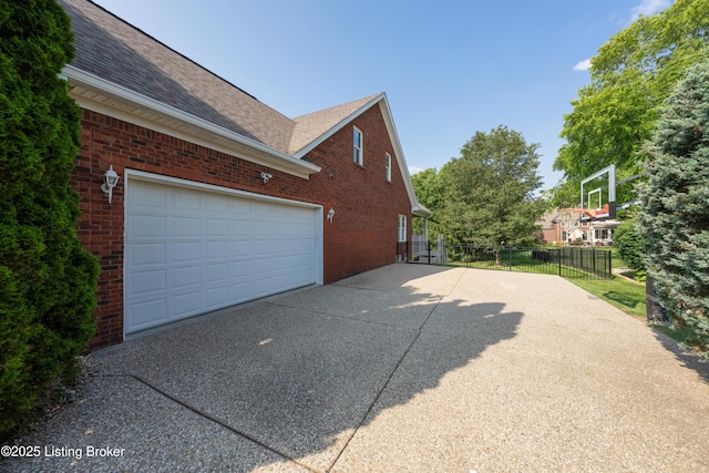 6205 Elizabeth Ct, Prospect, KY 40059 - view of property exterior featuring driveway, brick siding, and roof with shingles