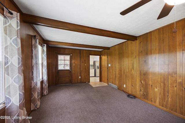 6704 Hollow Tree Rd, Louisville, KY 40228 - entryway featuring a ceiling fan, carpet floors, beam ceiling, and wood walls