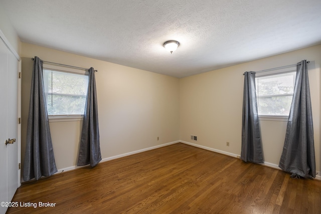 6704 Hollow Tree Rd, Louisville, KY 40228 - spare room with wood finished floors, healthy amount of natural light, and a textured ceiling
