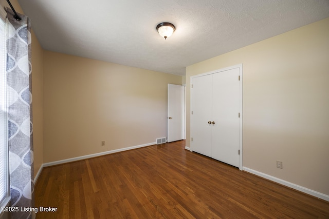 6704 Hollow Tree Rd, Louisville, KY 40228 - unfurnished bedroom with wood finished floors and a closet