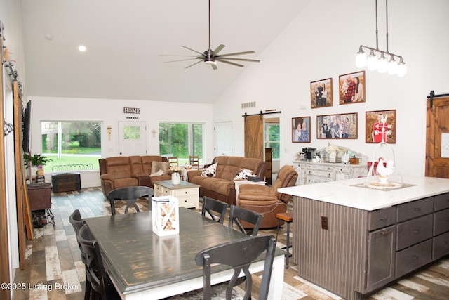 9115 Independence School Rd, Louisville, KY 40228 - dining space with a barn door, high vaulted ceiling, a ceiling fan, and recessed lighting