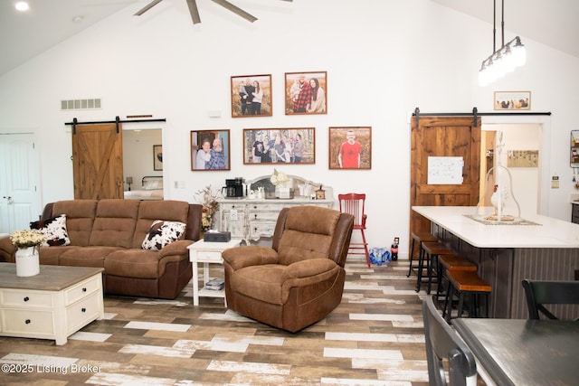9115 Independence School Rd, Louisville, KY 40228 - living area featuring a barn door, high vaulted ceiling, wood finished floors, and ceiling fan
