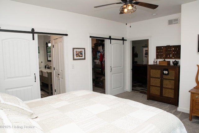 9115 Independence School Rd, Louisville, KY 40228 - carpeted bedroom with a barn door, a walk in closet, a closet, and connected bathroom