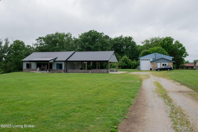 9115 Independence School Rd, Louisville, KY 40228 - view of front of house featuring a front yard, stone siding, dirt driveway, a metal roof, and a garage